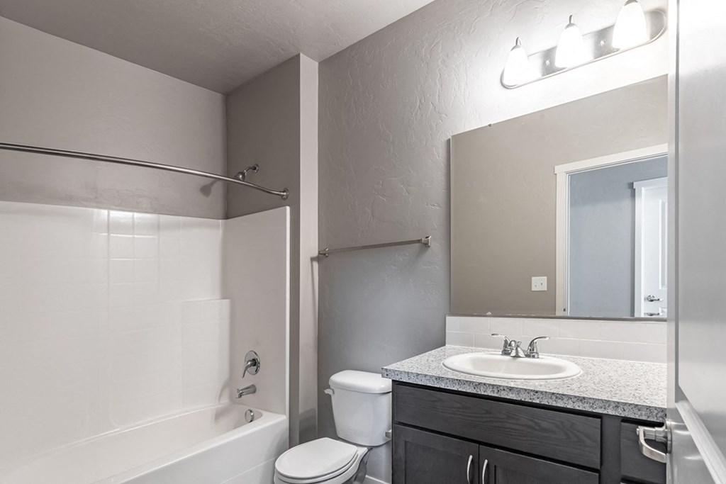 a bathroom with a toilet sink and bathtub