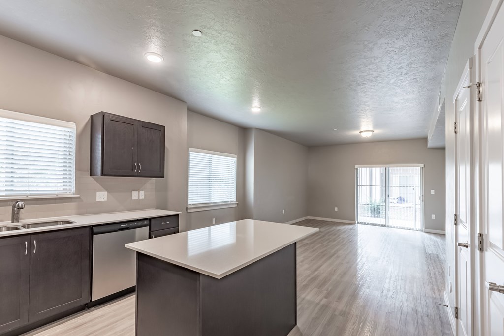 A kitchen with a white countertop and dark cabinets. at Harper Ridge Apartments, Meridian, ID
