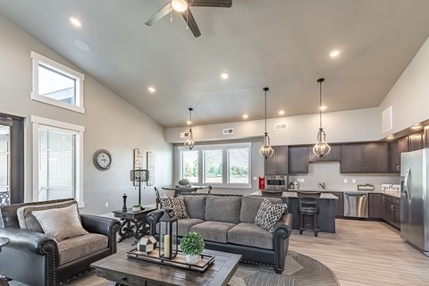 A modern living room with a grey couch and a wooden coffee table.