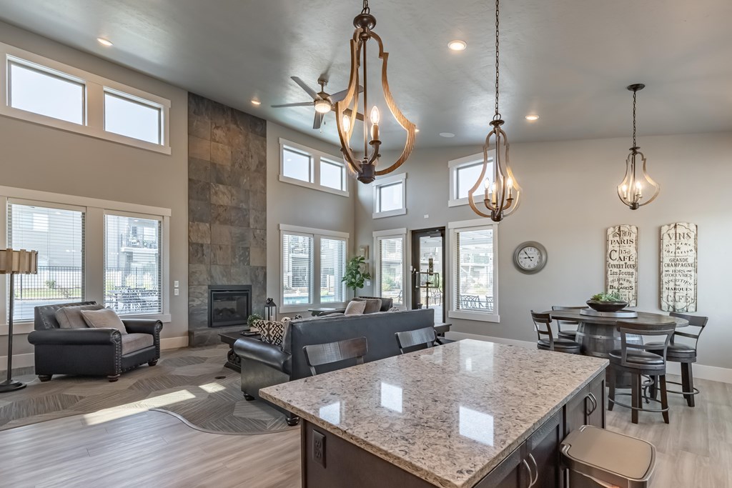 A modern kitchen with a large island and a dining table. at Harper Ridge Apartments, Meridian, ID, 83642