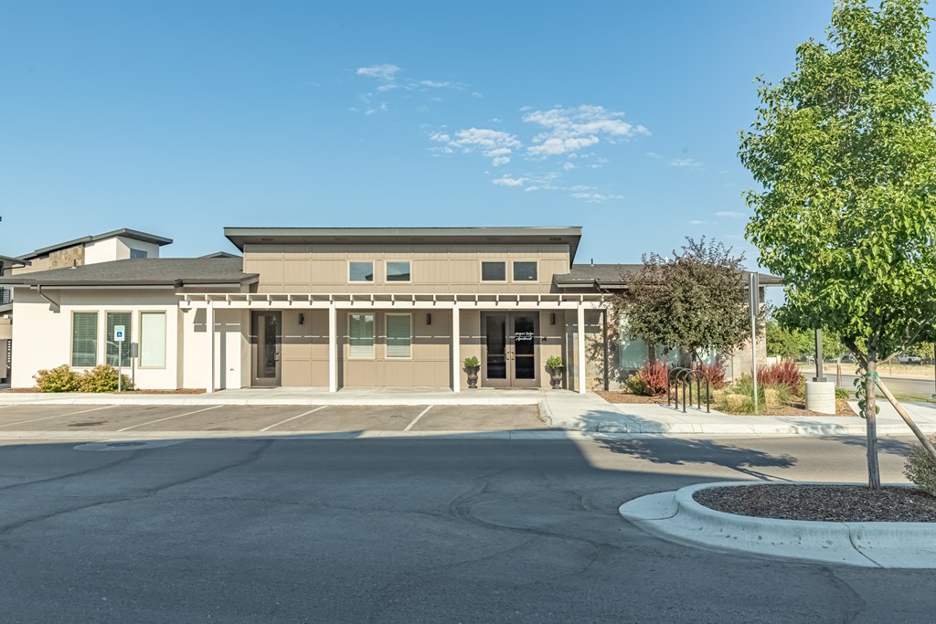A building with a parking lot in front of it. at Harper Ridge Apartments, Meridian