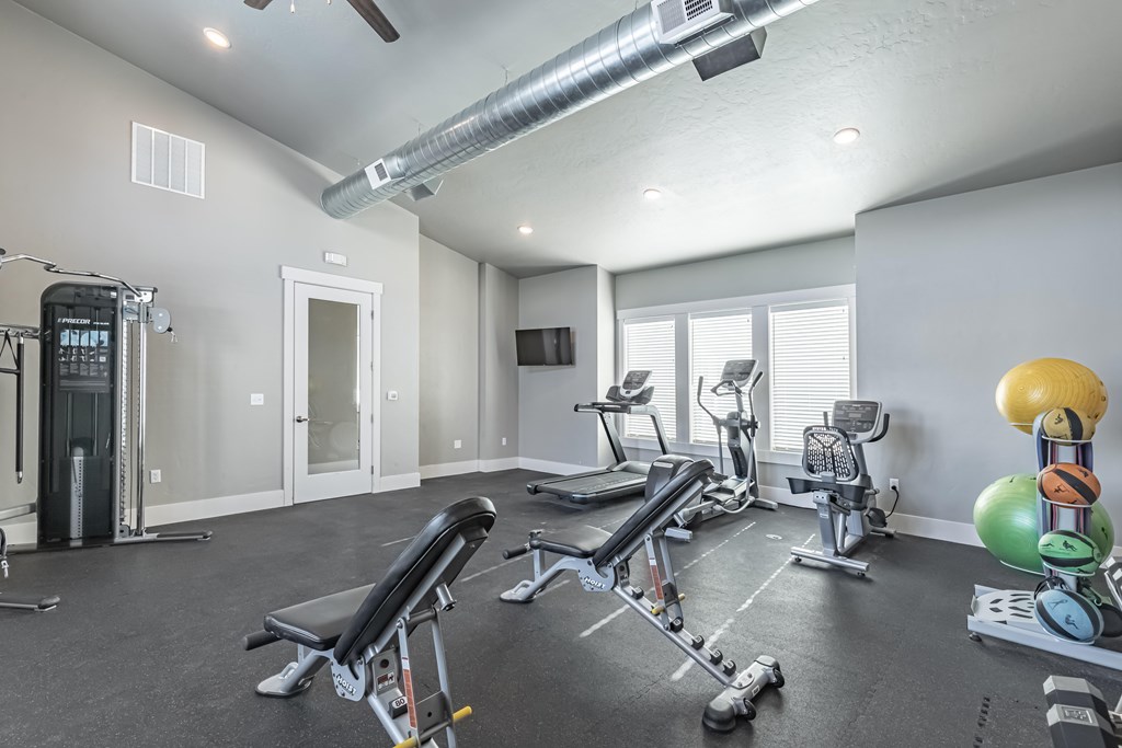 A spacious home gym with a variety of exercise equipment. at Harper Ridge Apartments, Meridian, Idaho