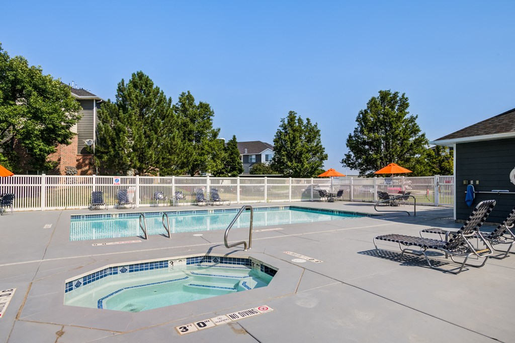 our resort style swimming pool is next to our building with two chaise lounge chairs