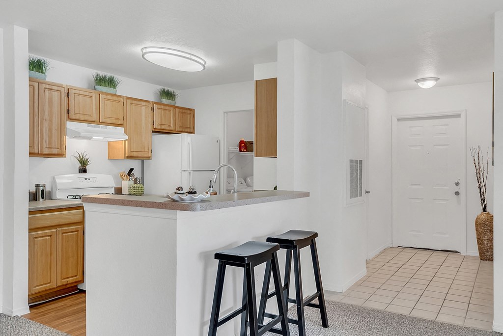 a kitchen with a counter top with two stools