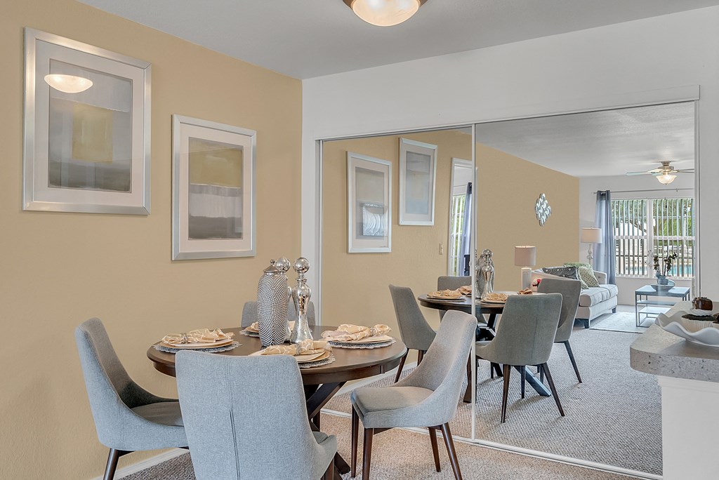 an open living room and dining room with a table and chairs