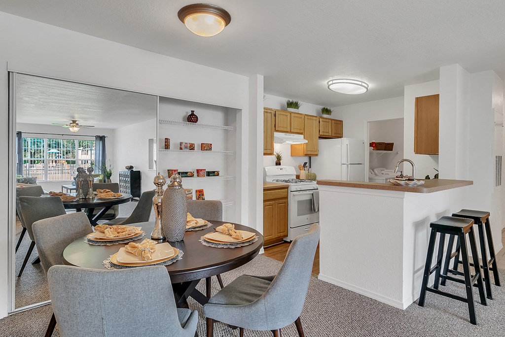 an open kitchen and dining area with a table and chairs