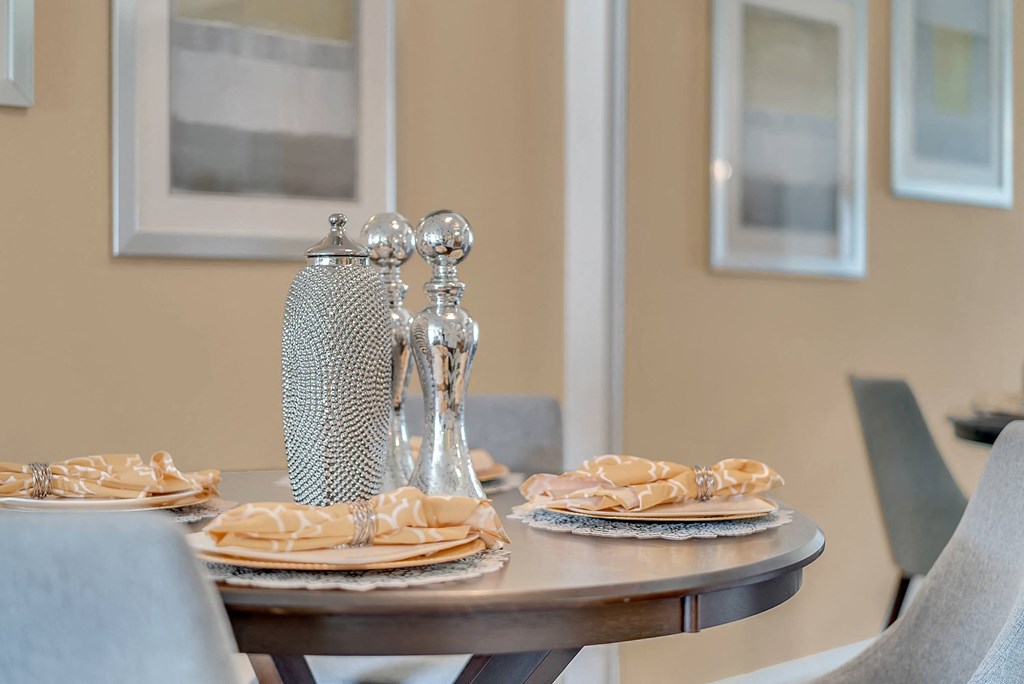 a dining table with plates and silverware on it