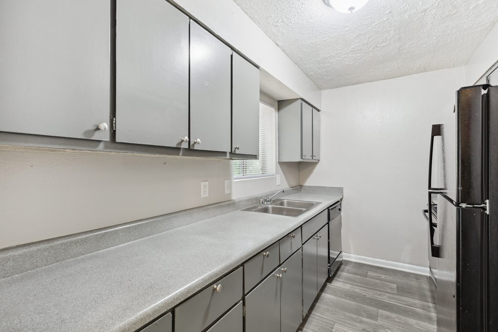 the kitchen of our studio apartment atrium with stainless steel appliances and white cabinets
