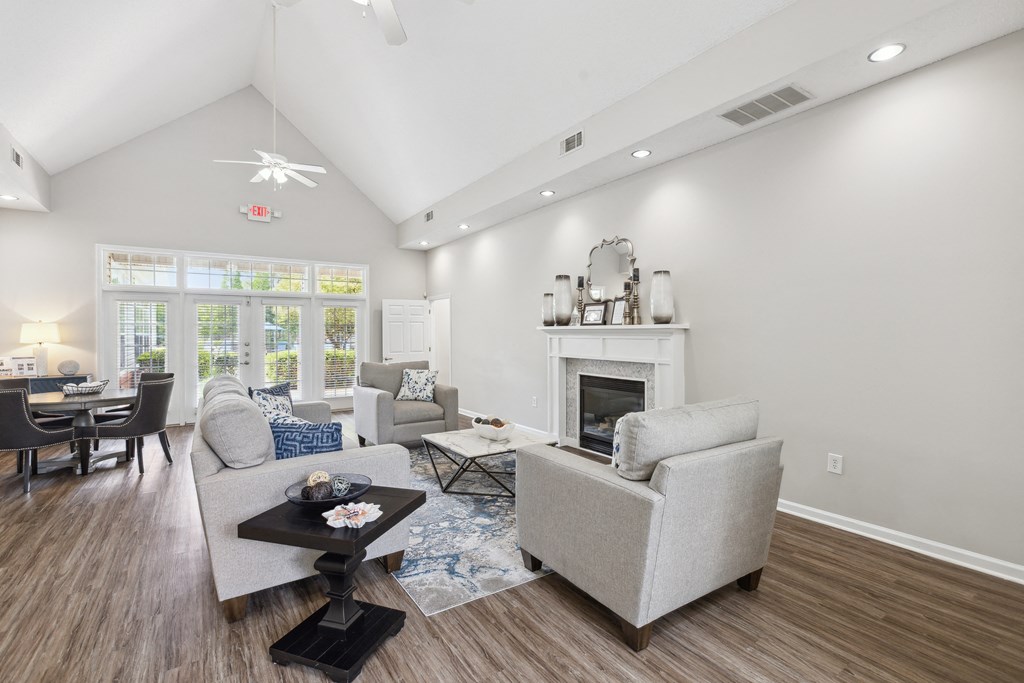 a living room with couches and chairs and a fireplace