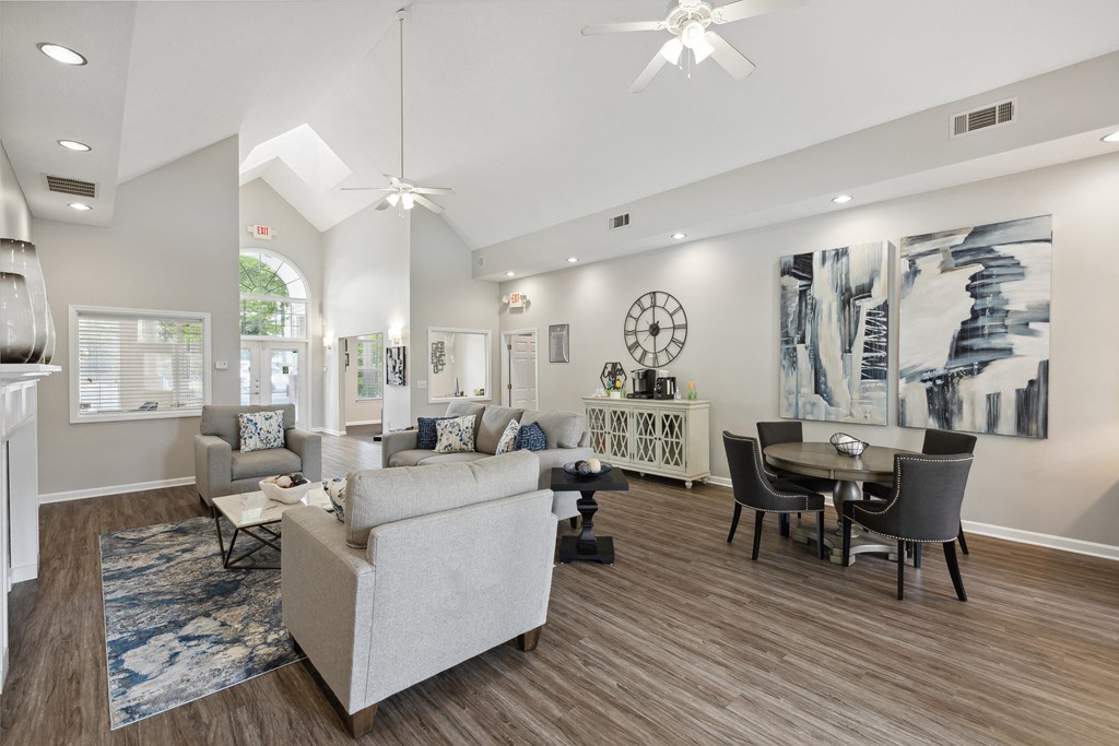a living room with couches and chairs and a dining room table