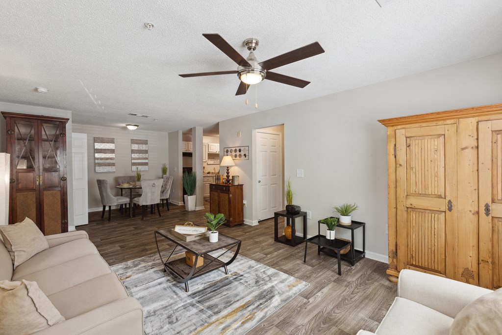 a living room with a couch and a ceiling fan