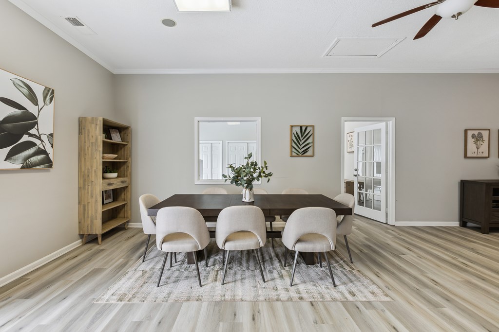 an image of a dining room with a table and chairs