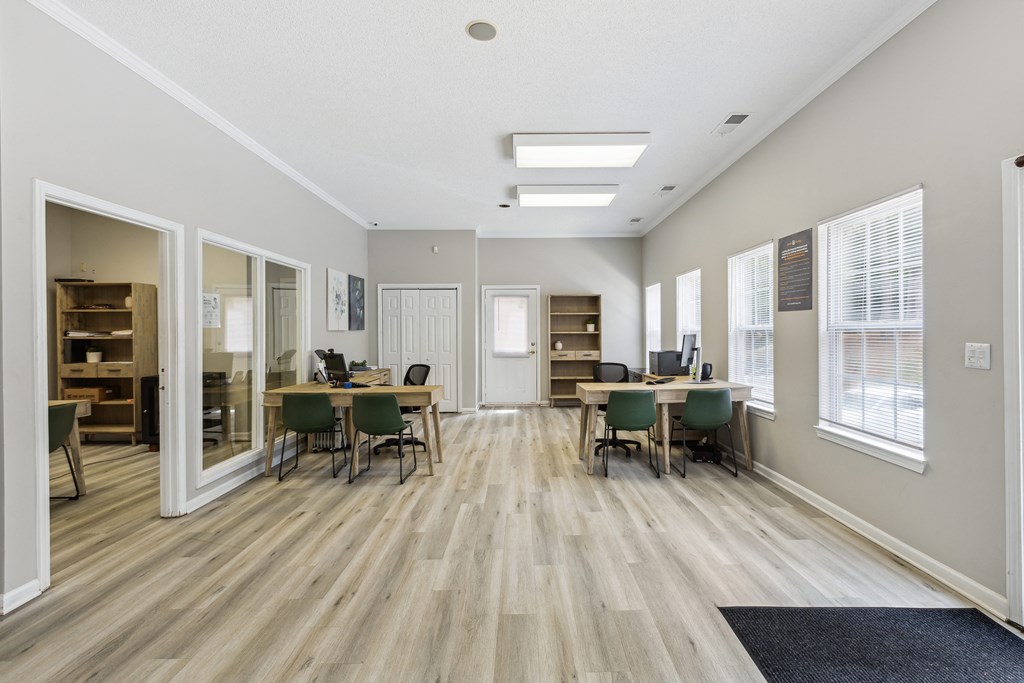 a dining room with a table and chairs in front of a window