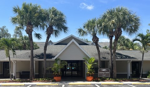 a building with palm trees in front of it