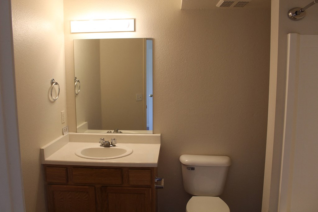 a small bathroom with a toilet sink and mirror