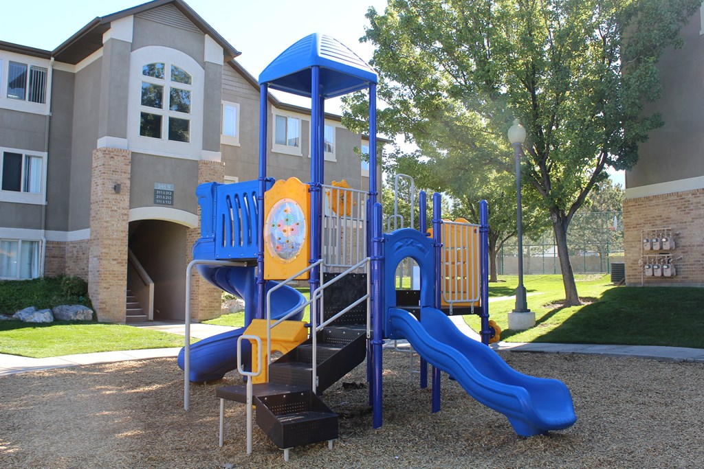 a playground in front of an apartment building