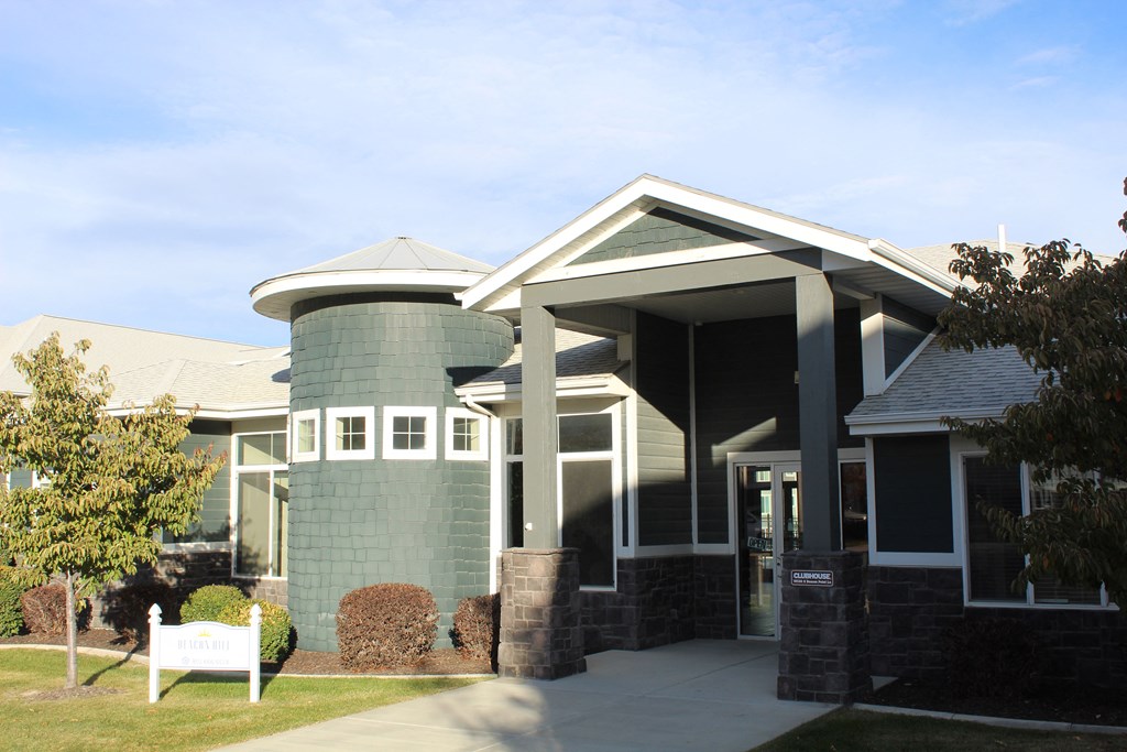 the front of a building with a white bench in front of it