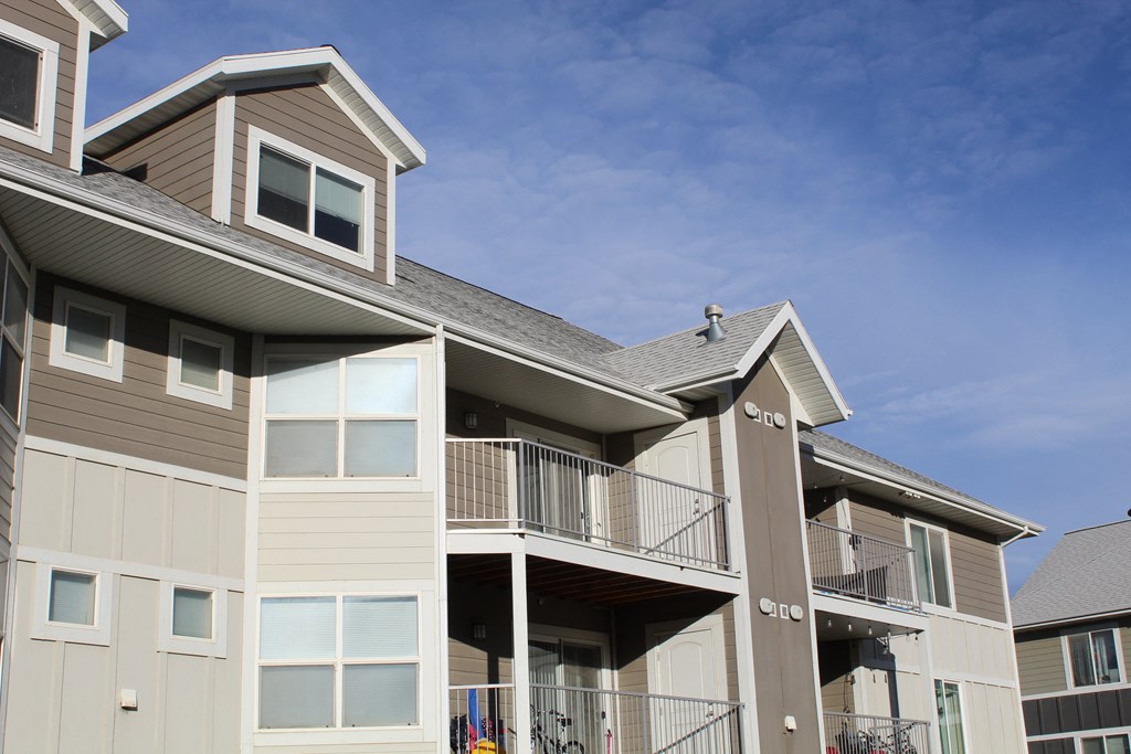 a view of a building with a balcony and a blue sky