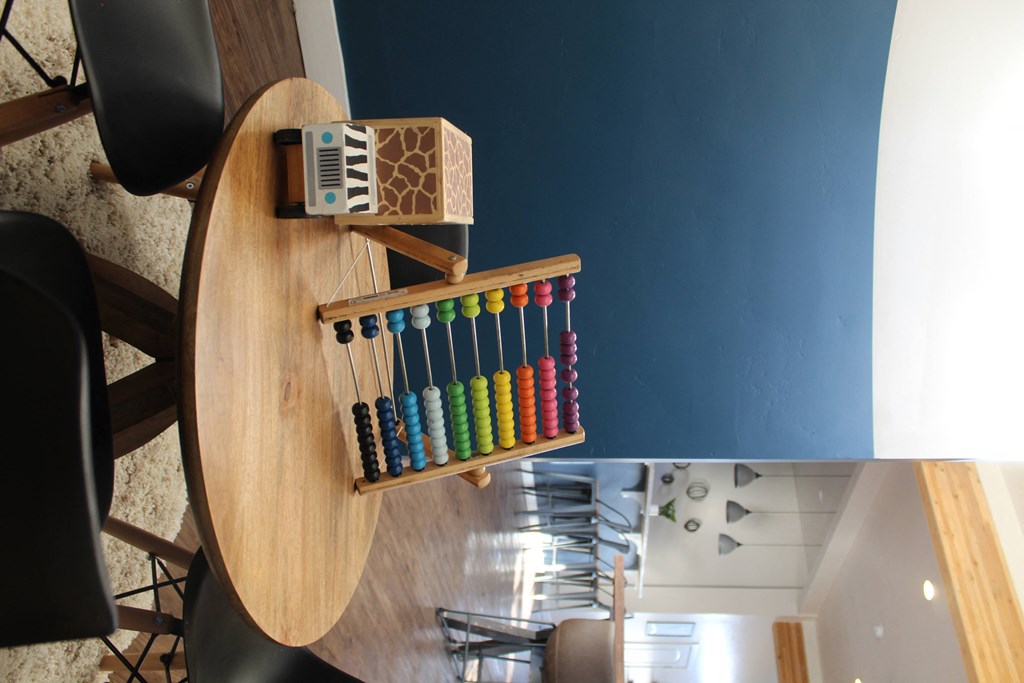 a rack of colored crayons on a wooden table