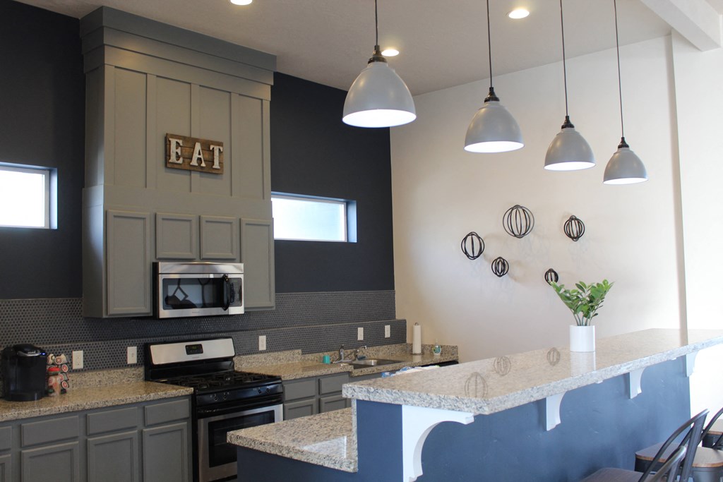 a kitchen with a counter top and a stove