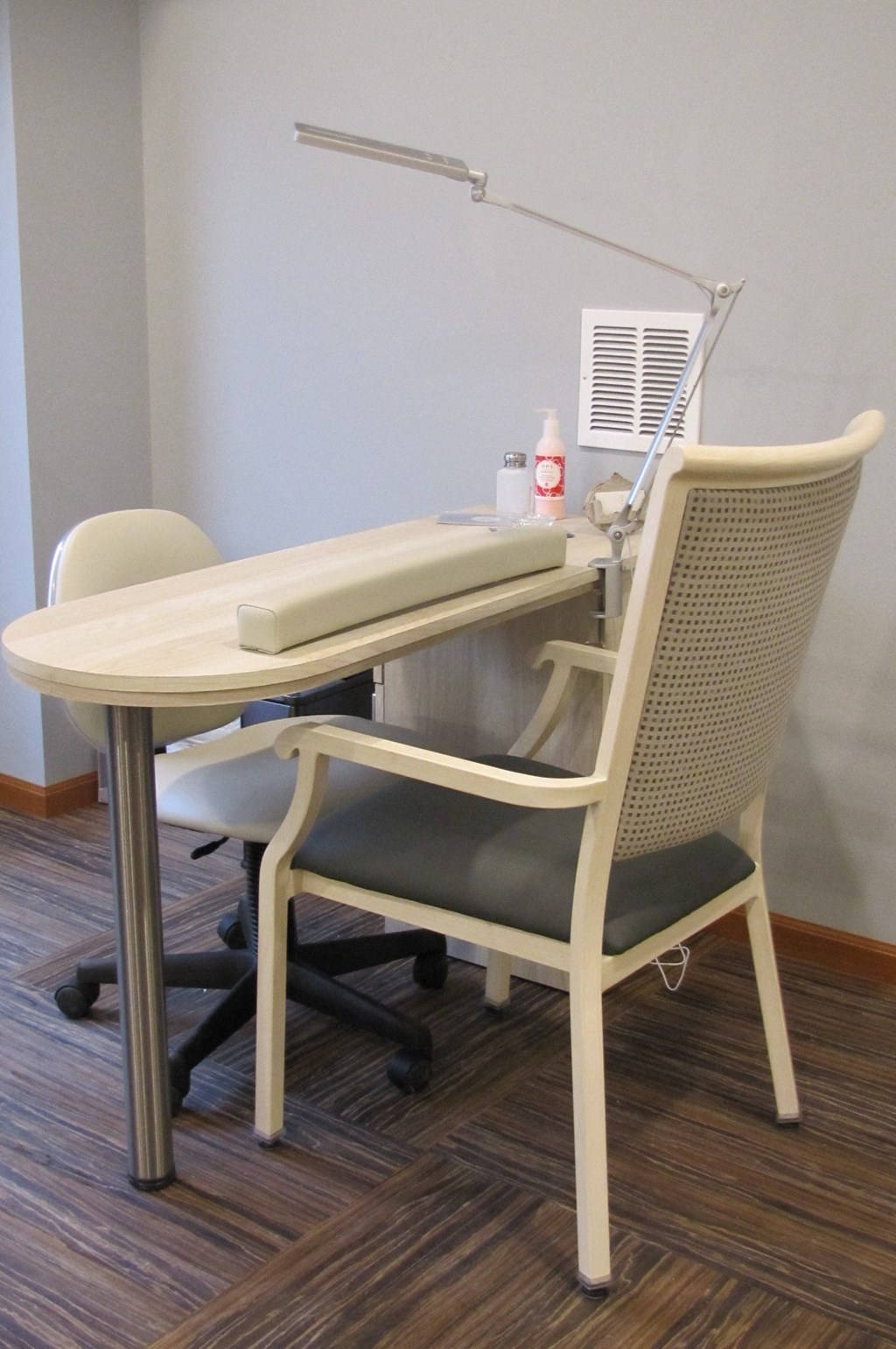 a desk with a chair and a table with a air conditioner
