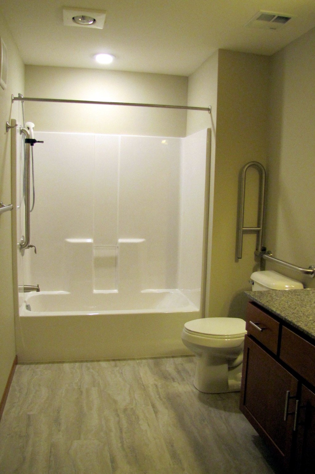 a bathroom with a shower and a toilet and a sink