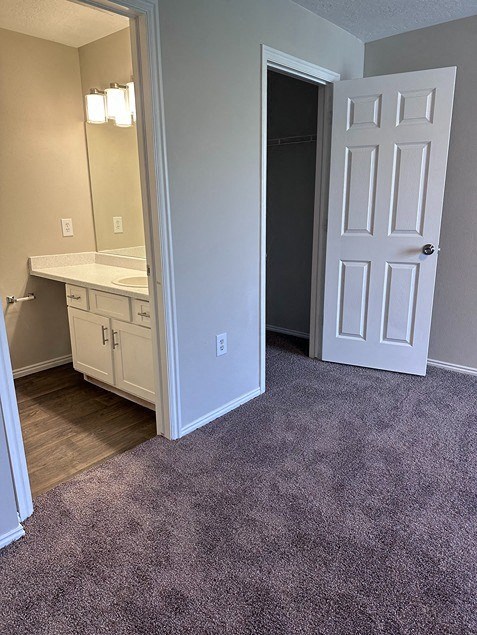an empty bathroom with a sink and a door