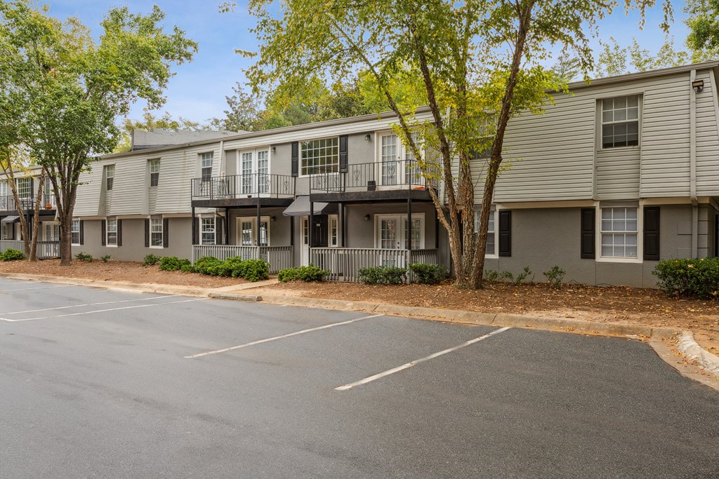 an empty parking lot in front of an apartment building