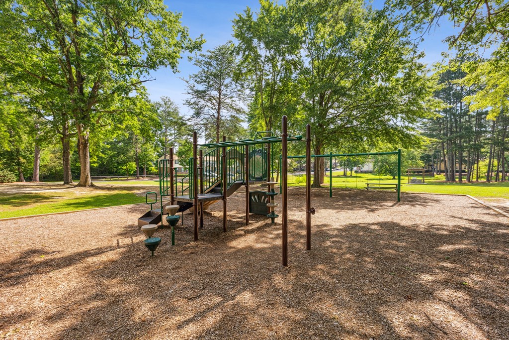 A playground with a swing set and a slide.