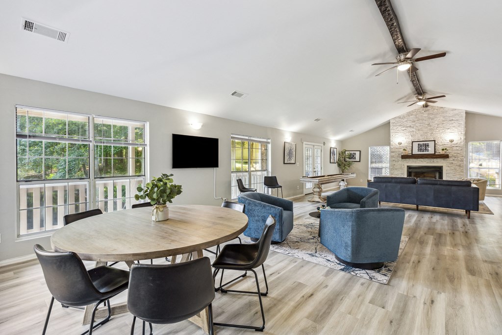 a living room with a table and chairs and a fireplace