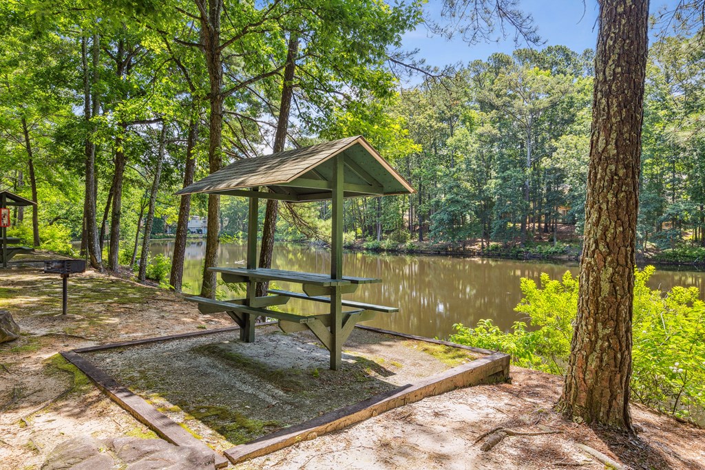a picnic table next to a body of water