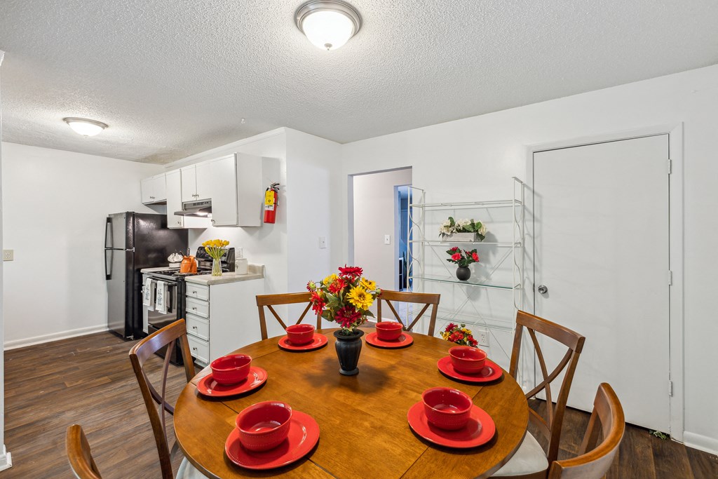 a kitchen and dining room with a table and chairs