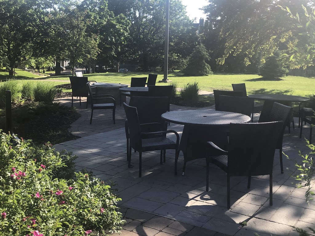 a patio with tables and chairs in a park