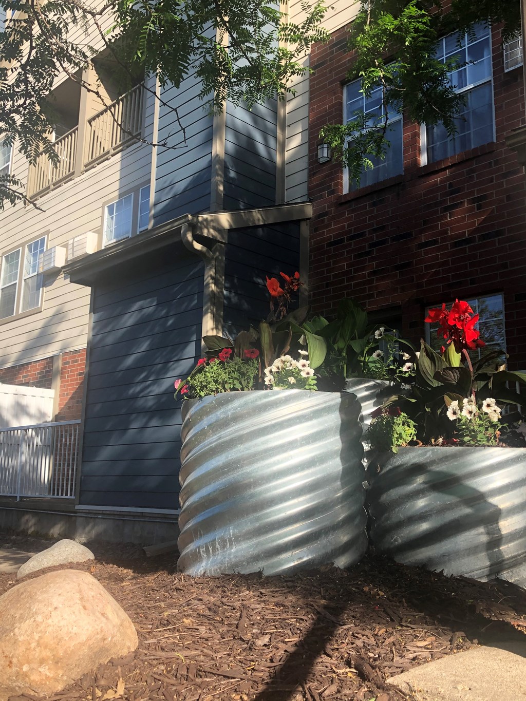 a large metal planter in front of a house
