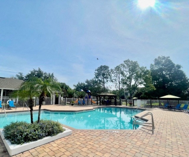 a swimming pool with a blue sky in the background