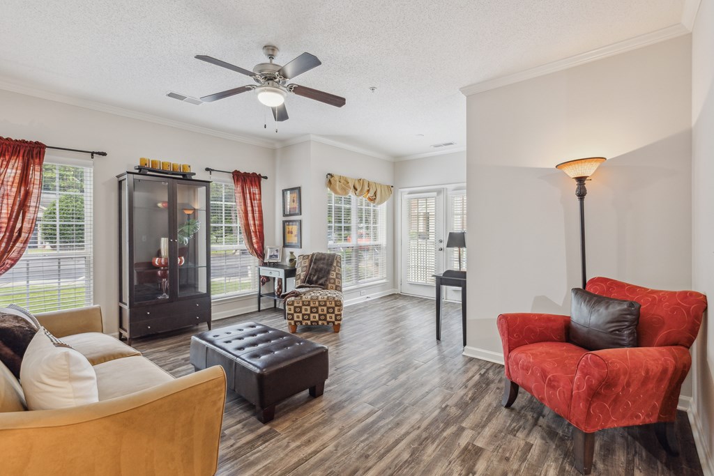 a living room with furniture and a ceiling fan