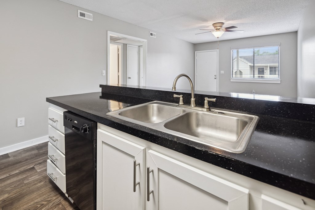 an empty kitchen with a sink and a window
