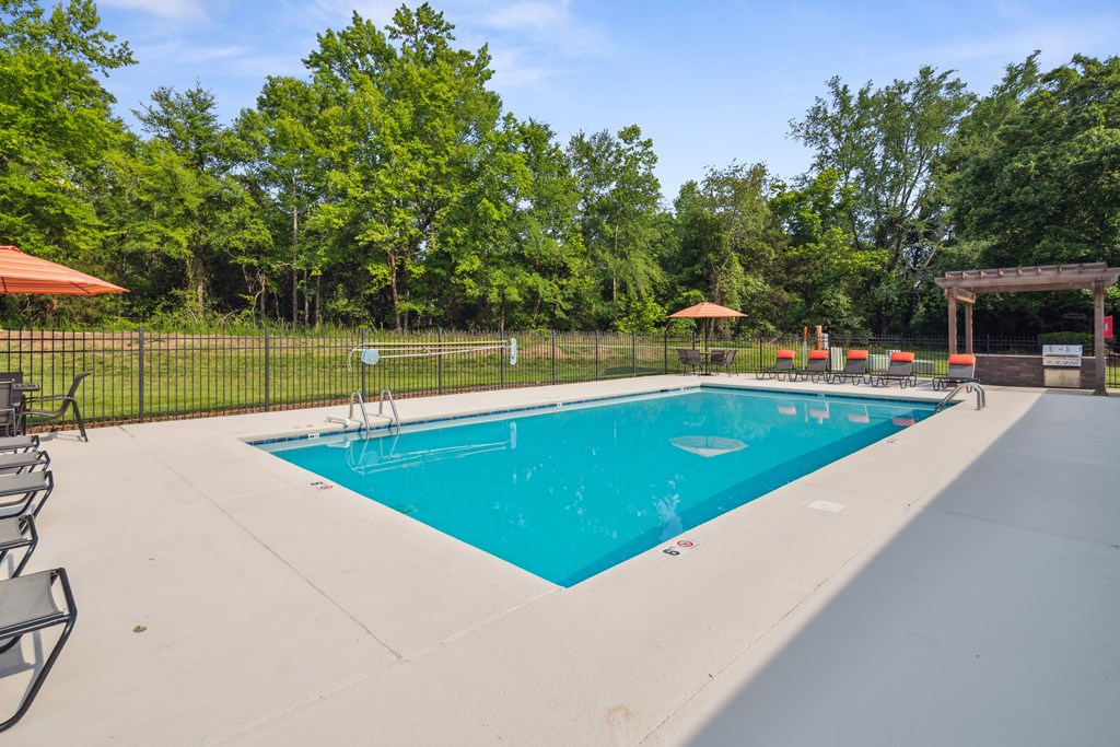 the swimming pool at our apartments with a blue pool