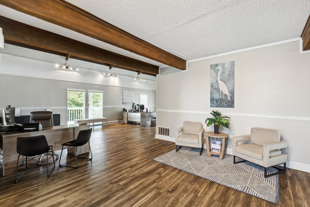 A room with wooden floors and a large painting on the wall.