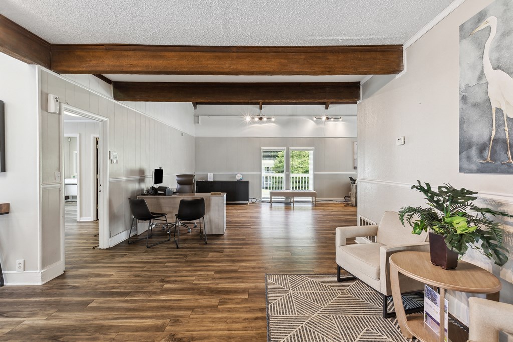 the living room and dining room of a home with wood floors and white walls
