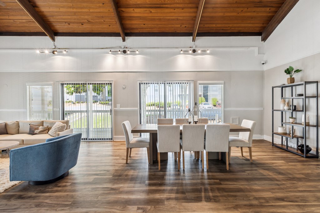 a living room and dining room with a table and chairs