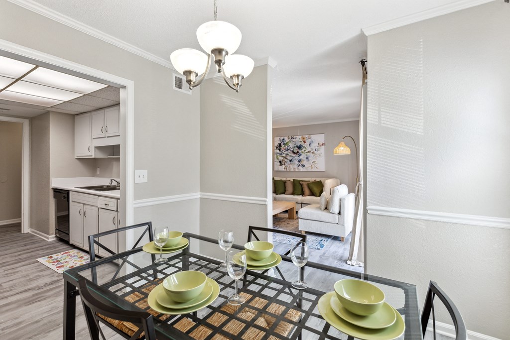 a dining room with a glass table and chairs