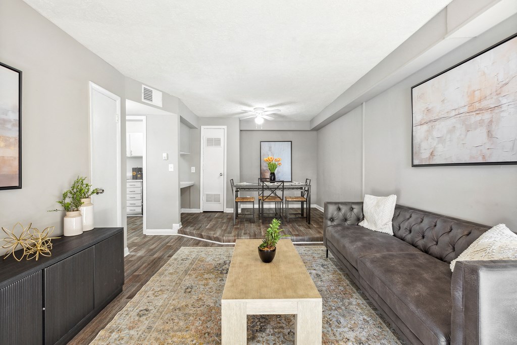 A living room with a grey couch and a coffee table.
