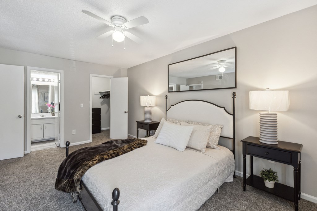 a bedroom with a bed and a ceiling fan