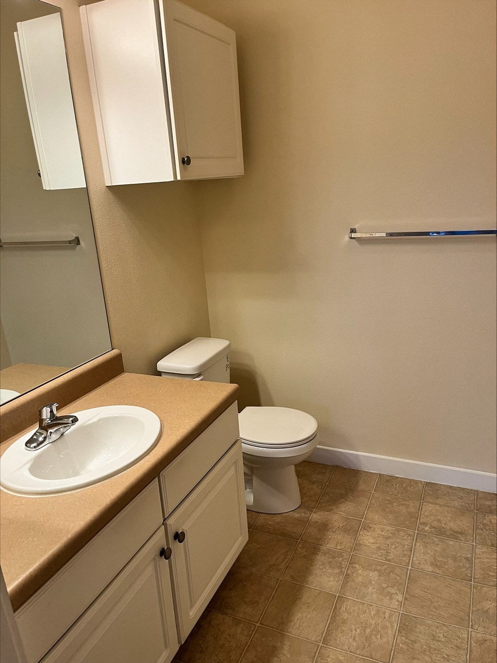 a bathroom with a sink toilet and mirror