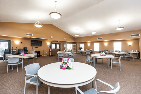 a multipurpose room with tables and chairs