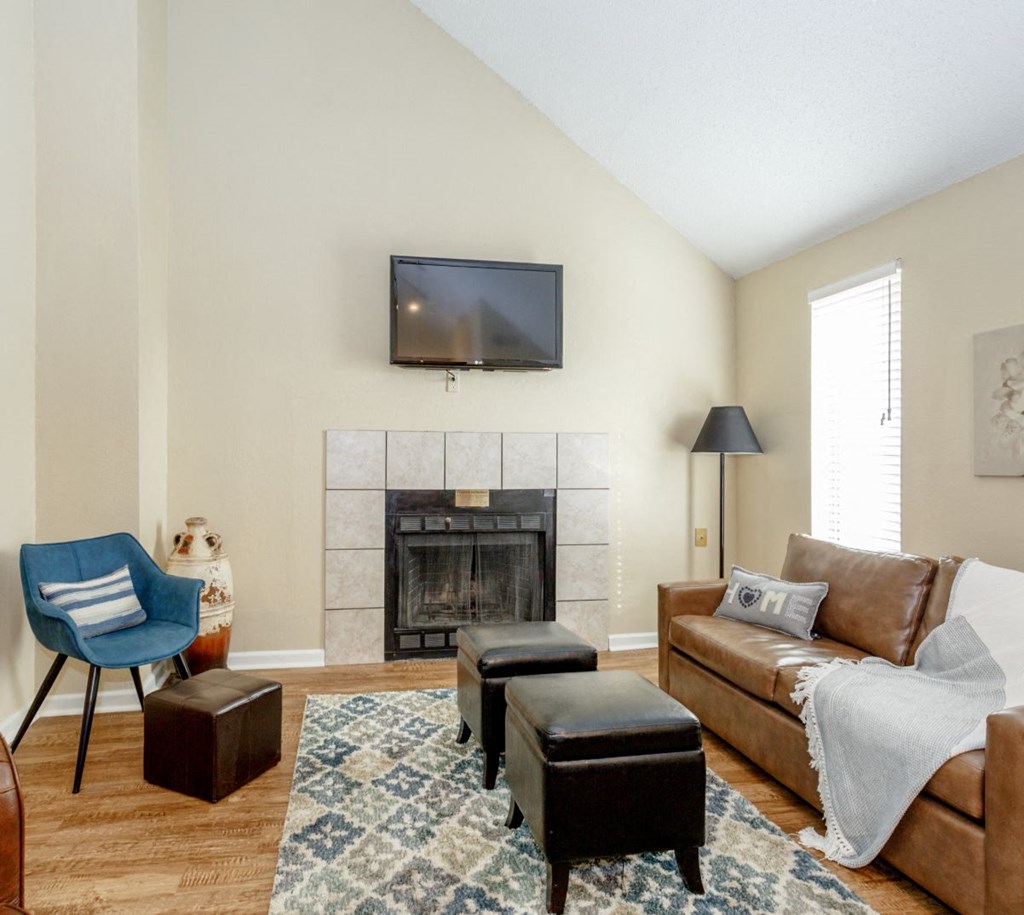 a living room with a fireplace and a tv above it