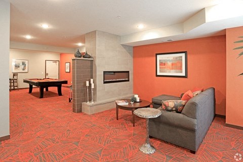 a living room with a couch and a pool table