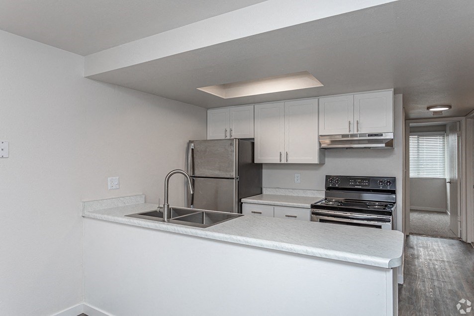 a kitchen with white cabinets and stainless steel appliances