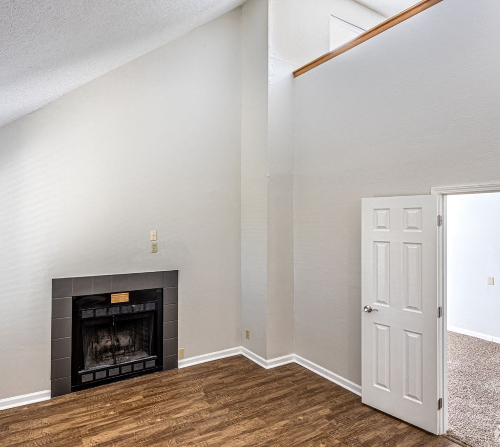 a living room with a fireplace and a door